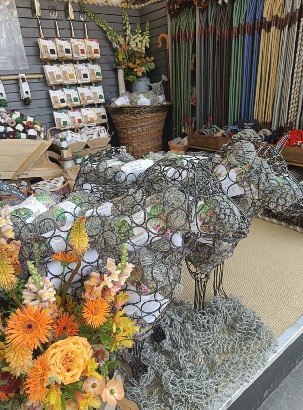 twool sheep on the stand at chelsea flower show - garden netting on the ground